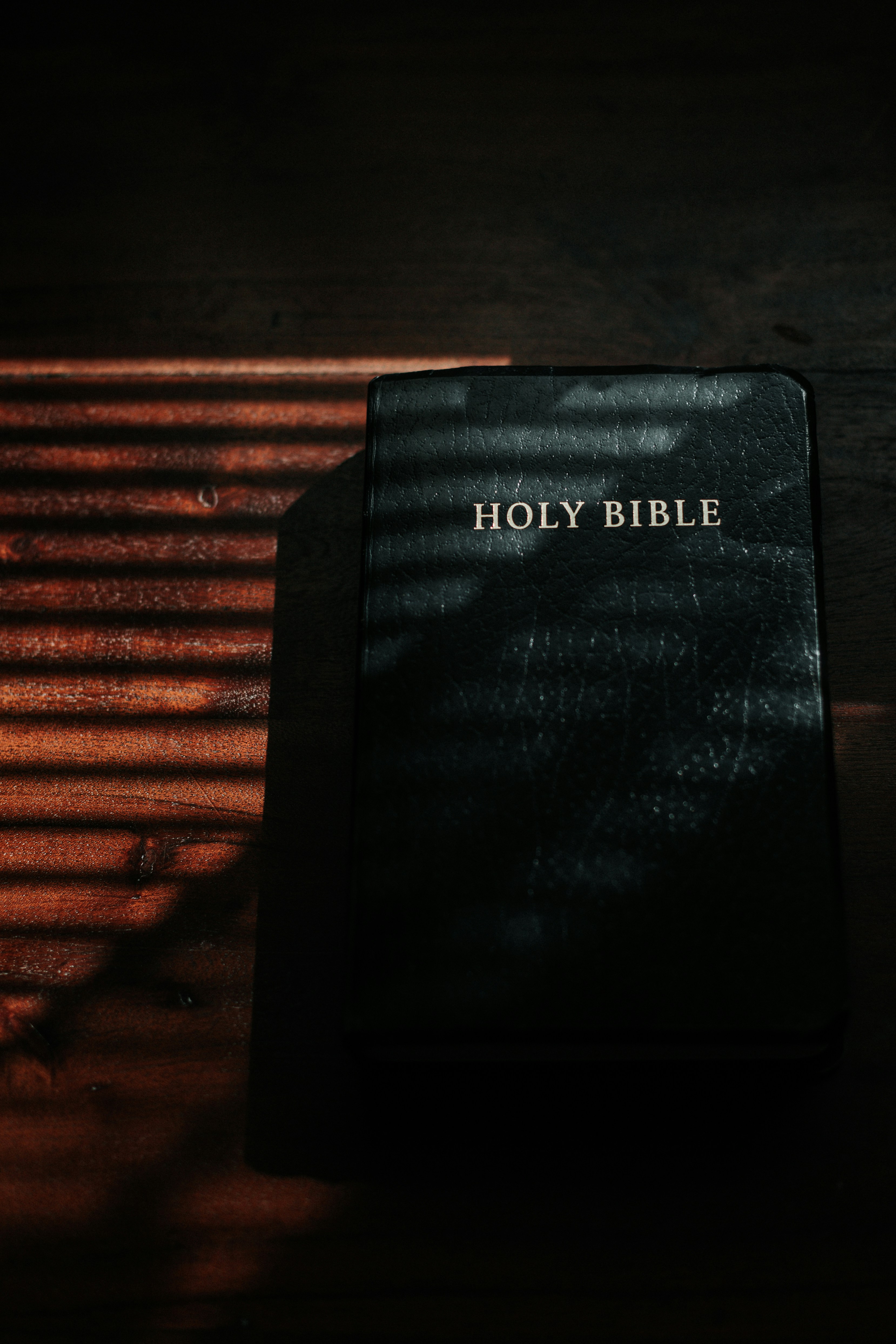 Bible laying flat on wooden table